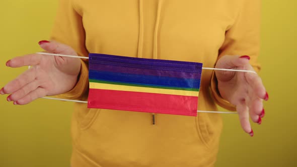 Body Part of Woman with Protective Rainbow Mask