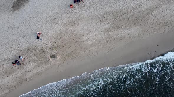 Top-down aerial birdseye view drone shot of people chilling on a beach in Sayulita, Mexico