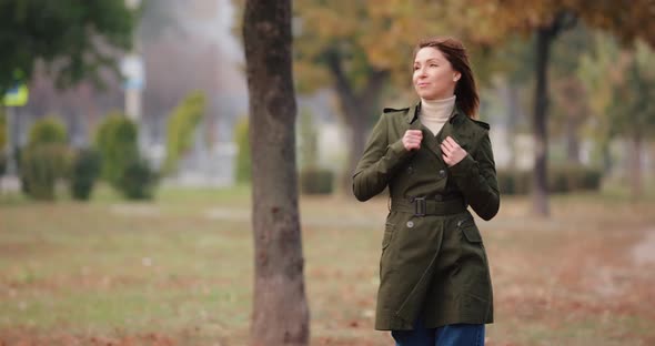 Woman Walking Along Autumn Alley