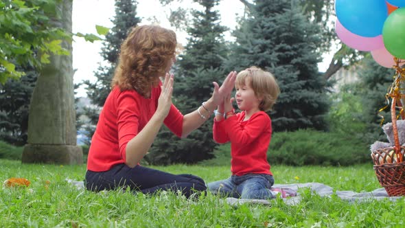 Mother Playing with Her Daughter Outdoor in Nature