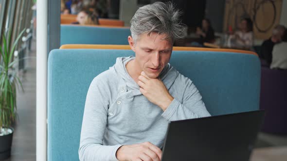 Sick Looking Man Using Laptop