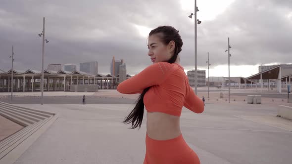 Young Caucasian Woman in Sportswear Stretching Her Warm Up Body Before Outdoor Workout