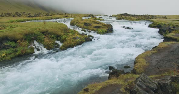 Cascades of Foss Waterfall with Blue Water in Iceland