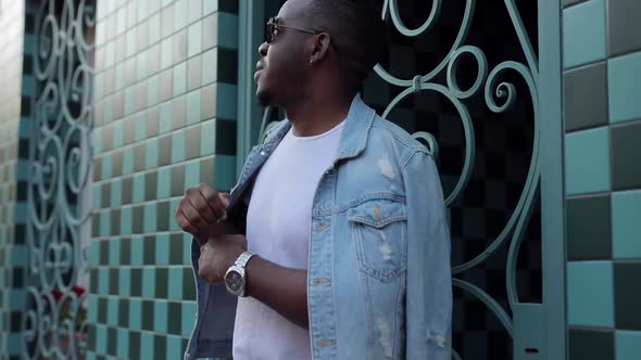 African Man in Black Glasses and a White T-shirt Dancing