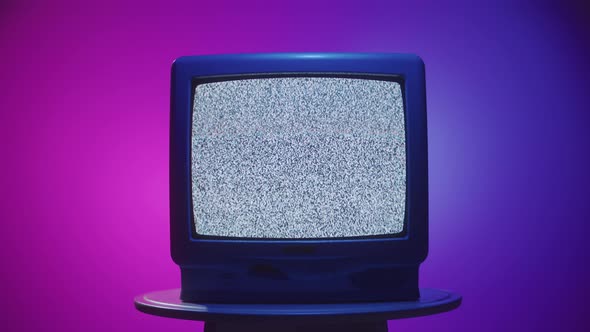 Old Vintage Television on Purple Neon Background Closeup