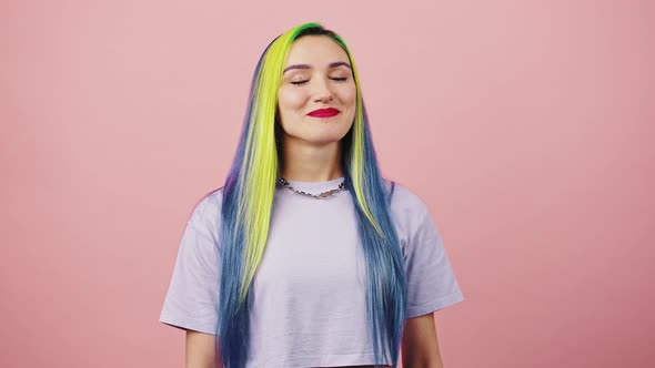 Young Positive Woman with Rainbow Colored Hairstyle Making Enjoyment Gesture and Saying Bellissimo