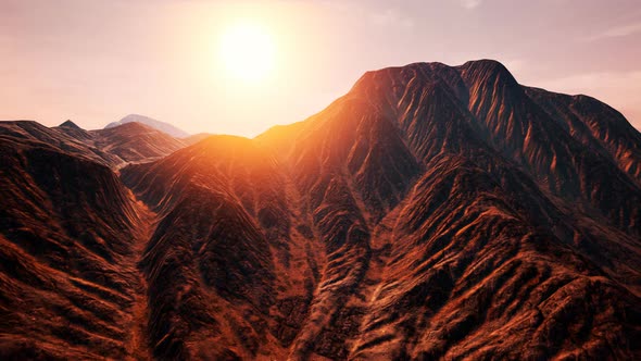 Sun Rays Over Mountains in a Valley