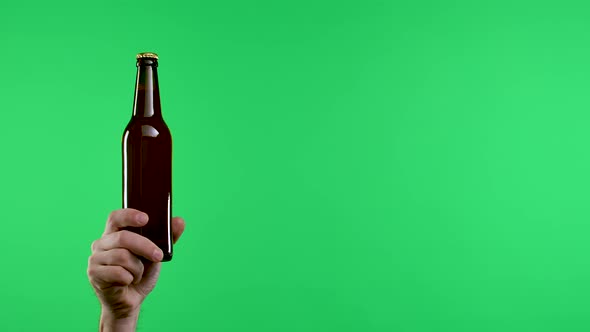 Male Hands Hold a Dark Brown Bottle of Beer or Lemonade Then the Arms are Folded to Show the No Stop