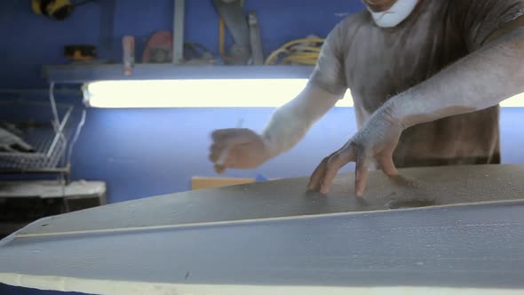 Man making new surfboard