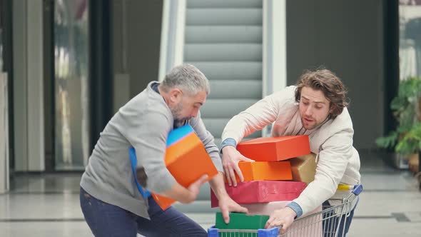 Shopaholics Compete for Purchases By Taking Boxes From Each Other