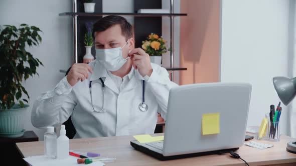 Portrait of a Doctor Putting on a Protective Mask