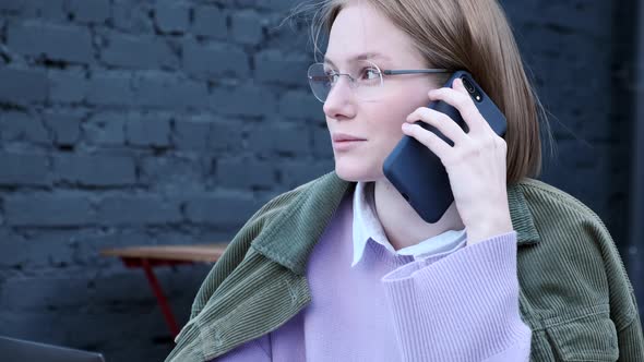 Concentrated Short Haired Lady Talks on Black Smartphone