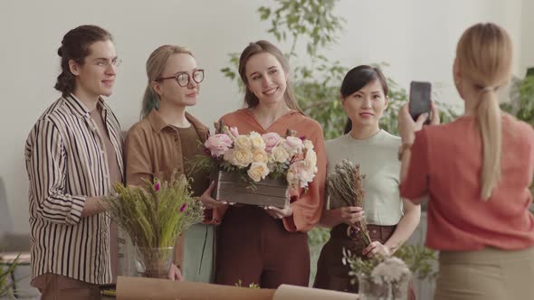 Woman Taking Picture of Florists with Flowers