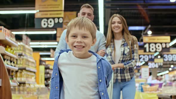 Happy Kid Enjoying Shopping with Parents