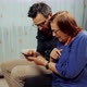 Senior Grandmather With Grandson Looking On Smartphone. Grandson Teaching Grandma Using Mobile Phone - VideoHive Item for Sale