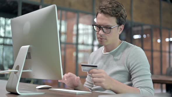 Ambitious Guy Adding Credit Card on Computer 