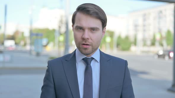 Portrait of Wondering Businessman Shocked by Loss Outdoor