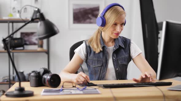 Photographer Retouching Photos on Computer