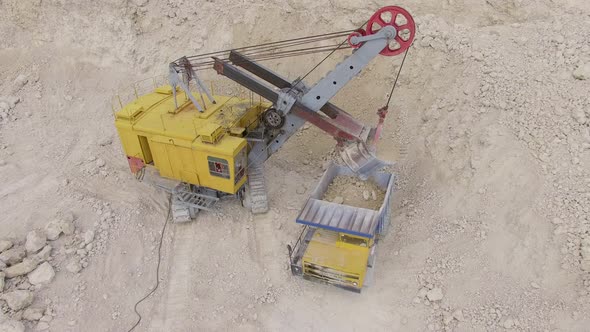 High angle of an excavator loading ballast