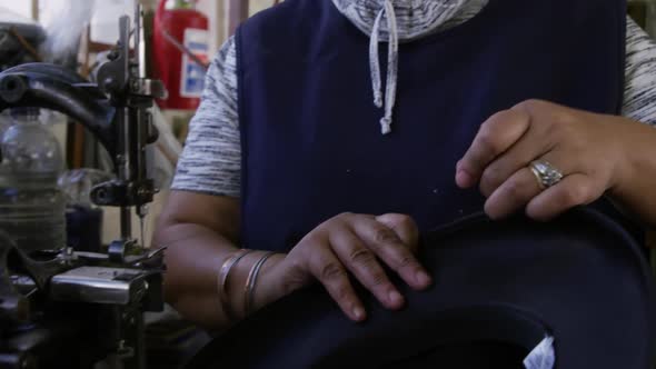 Mixed race woman working at a hat factory