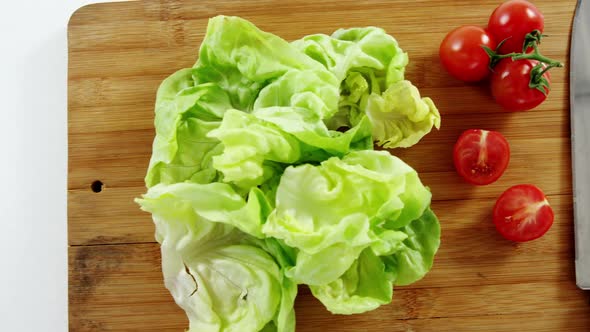 Vegetables and kitchen knife on chopping board