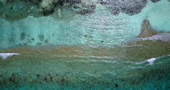 Natural fly over clean view of a sunshine white sandy paradise beach and aqua blue ocean background 