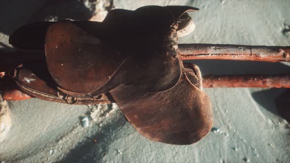 Rider Leather Saddle on Fence in Desert