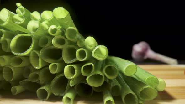 Green Onion Stalks Cut Into Pieces on Wooden Board