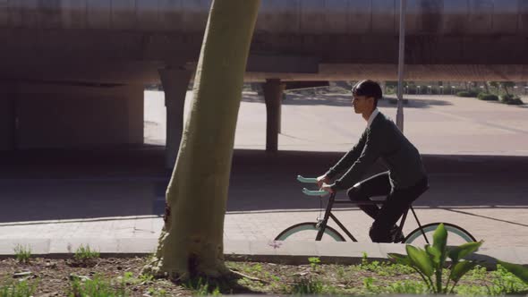 Transgender adult biking in the street