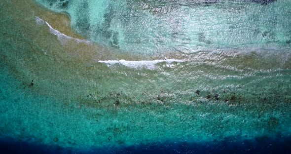 Luxury birds eye island view of a white sand paradise beach and blue sea background in colorful 4K