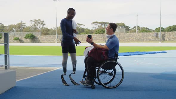 Two disabled athletics discussing over mobile phone 4k