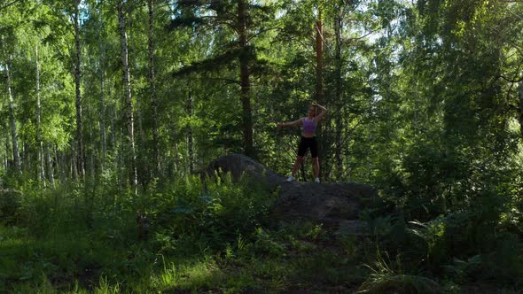 The Girl is Doing Fitness in the Forest