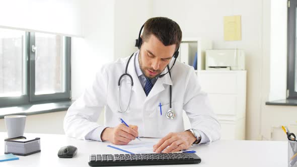 Male Doctor in Headset Having Video Call at Clinic