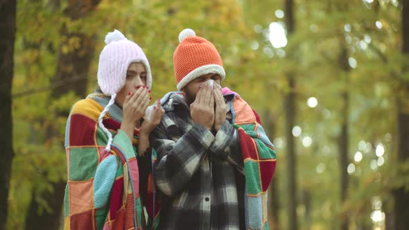 Young Couple with Handkerchief. Nose Wiper Near Autumn Tree. Napkin Sneezing in the Autumn Yellow