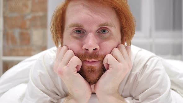 Close Up of Redhead Beard Man Face Lying in Bed