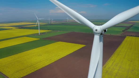 Aerial Close Up Shot of Wind Mills Rotating By the Force of the Wind