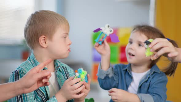 Children with Down Syndrome Have Fun in an Educational Therapy Lesson for Children with Disabilities