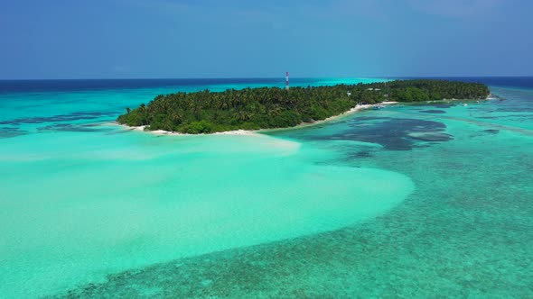 Wide angle flying clean view of a white paradise beach and aqua blue ocean background in colorful 4K