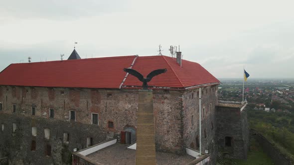 Aerial View of Medieval Castle on Mountain in Small European City at Cloudy Autumn Day