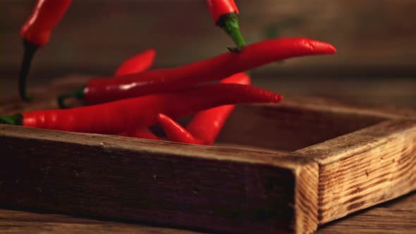 Super Slow Motion Chilli Pepper Falls on the Tray