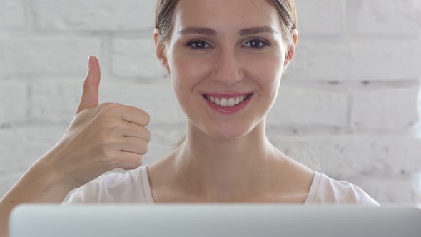 Thumbs Up by Woman in Loft Office