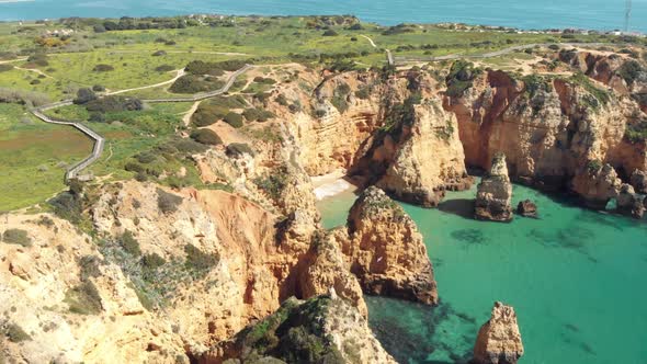Emerald Green sea bathing Ponta da Piedade cliffs in Lagos Algarve, Portugal