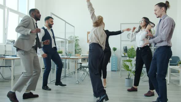 Slow Motion of Cheerful Employees Dancing Having Fun Celebrating Business Achievement