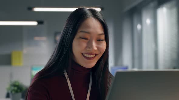 Happy Asian Entrepreneur in Smart Casual Finish Work on Laptop and Leave Workplace