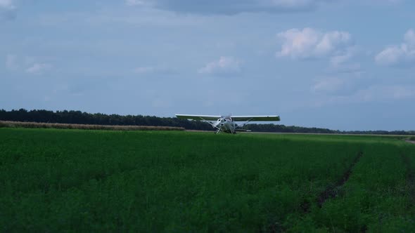 Lightweight Airplane Landing Airfield with Spinning Propeller Turning Off Engine