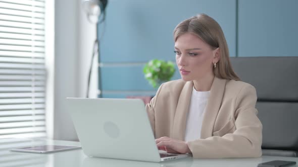 Businesswoman Working on Laptop in Office