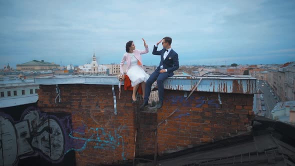 Wedding Couple High Five on the Roof