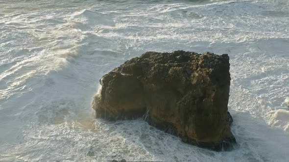 Huge Tide Smashing Against a Rock Formation Within Isolated Atlantic Area