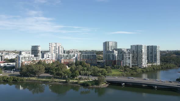 Aerial reveals shot of high rise waterfront apartment complexes on a sunny day