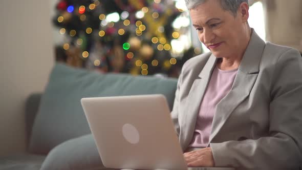 A Caring Elderly Man Brought a Mug of Tea to a Grayhaired Woman While She Was Sitting on the Couch